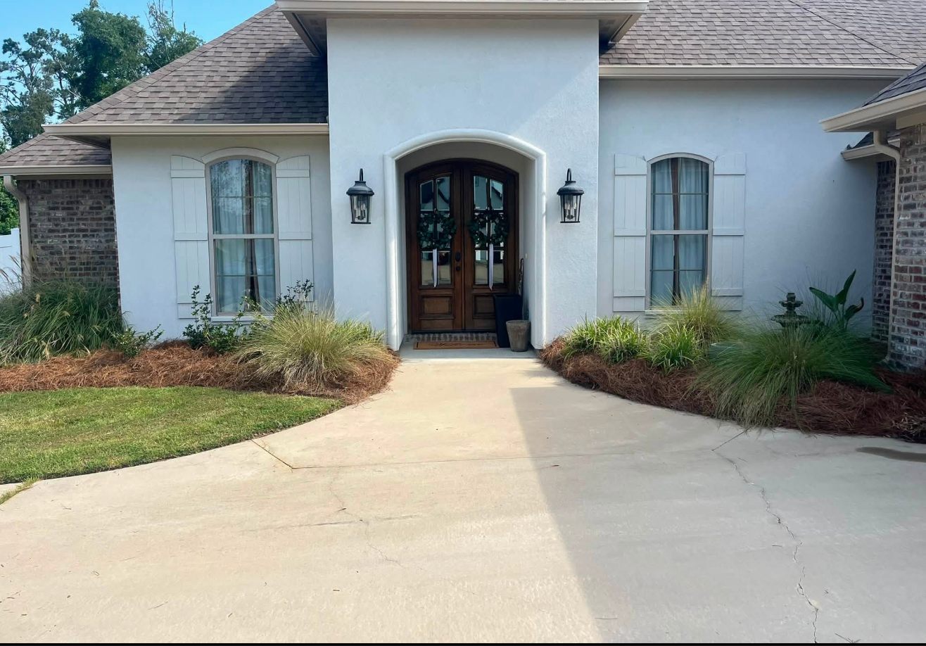 Pressure washed front entry and refreshed flowerbeds on a home in Ouachita Parish, Louisiana
